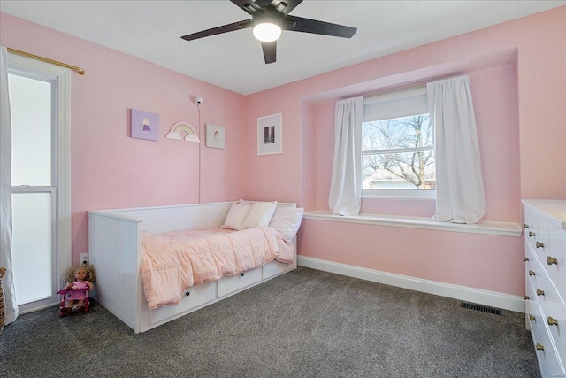 bedroom with a ceiling fan, carpet flooring, visible vents, and baseboards