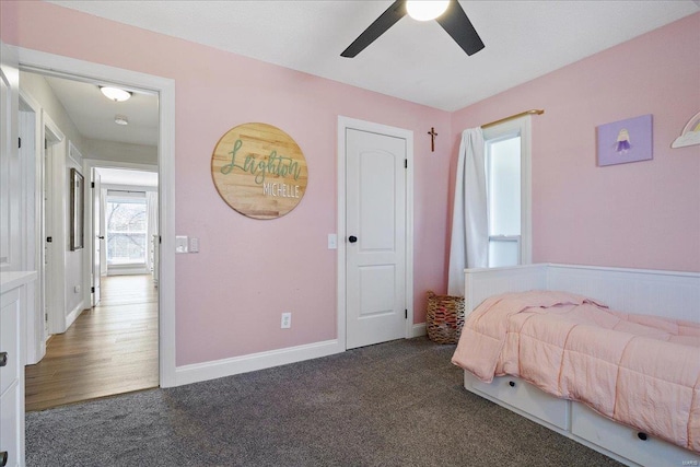 carpeted bedroom with a ceiling fan and baseboards