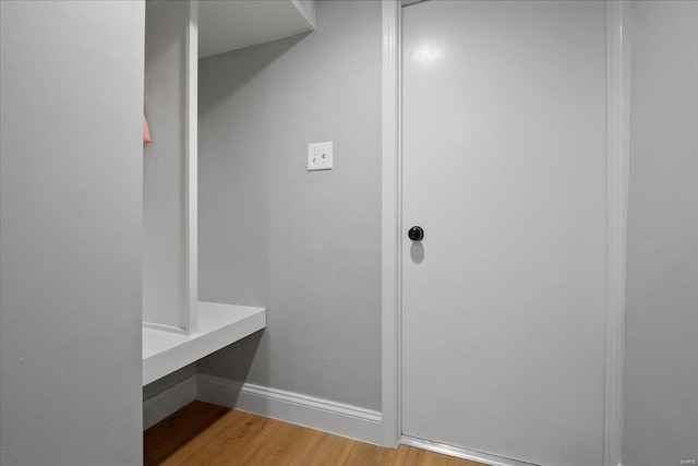 mudroom featuring wood finished floors and baseboards