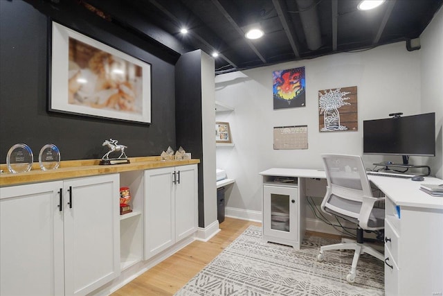 office area featuring baseboards and light wood-style flooring