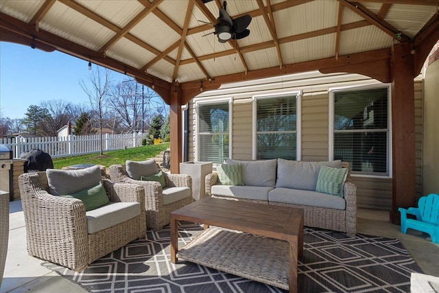 view of patio with a gazebo, an outdoor hangout area, ceiling fan, and fence