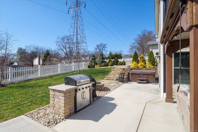 view of patio / terrace featuring a hot tub and a fenced backyard