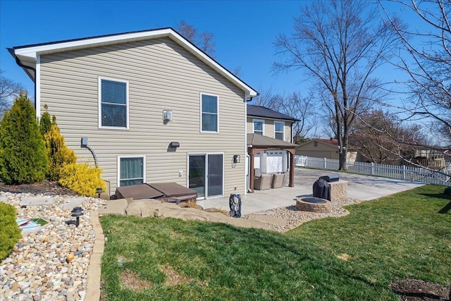 back of property featuring a patio, an outdoor fire pit, a lawn, and fence