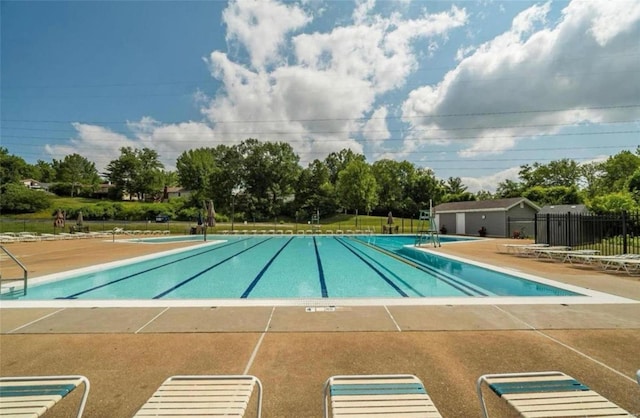 community pool featuring a patio area and fence