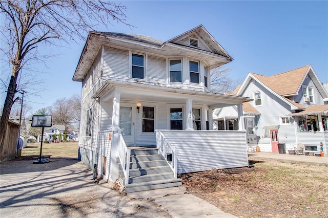 american foursquare style home with a porch