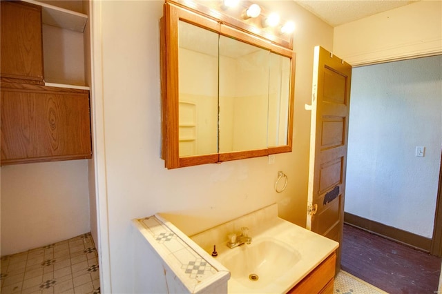 bathroom with vanity and baseboards