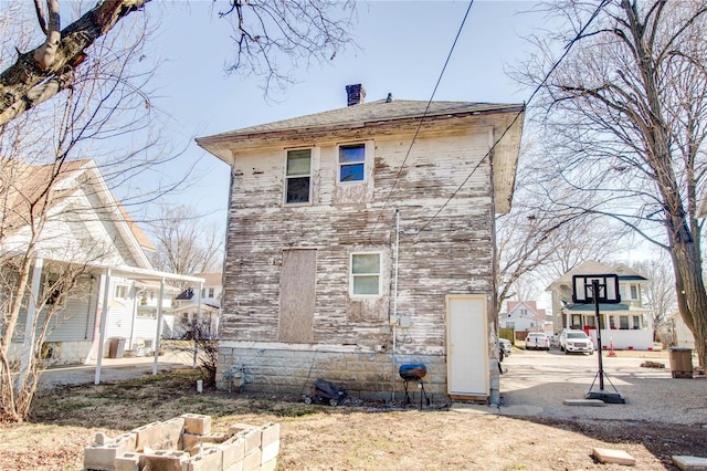 view of property exterior with a chimney