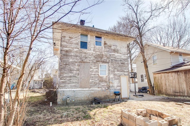 rear view of property with a chimney