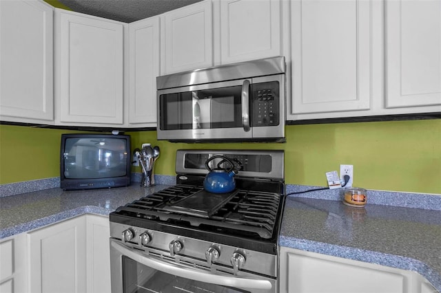 kitchen featuring white cabinets and appliances with stainless steel finishes