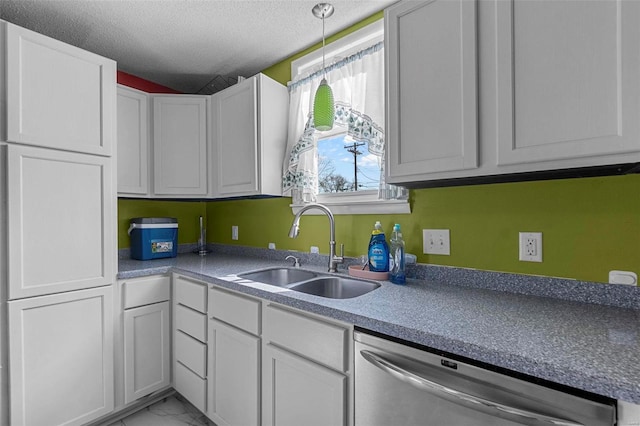 kitchen with pendant lighting, stainless steel dishwasher, marble finish floor, a textured ceiling, and a sink