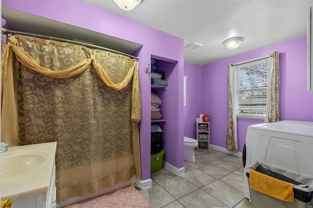 full bathroom with toilet, washer / clothes dryer, tile patterned flooring, baseboards, and vanity