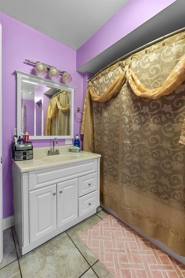 bathroom featuring tile patterned flooring and vanity