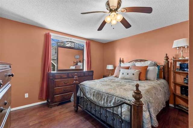 bedroom with baseboards, a textured ceiling, dark wood-style floors, and a ceiling fan