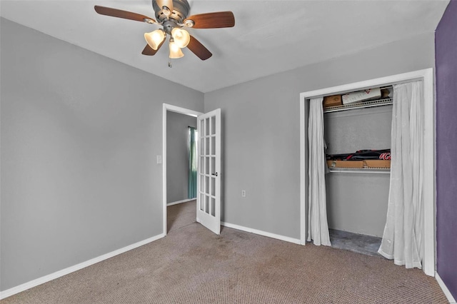 unfurnished bedroom with a ceiling fan, carpet flooring, baseboards, and a closet