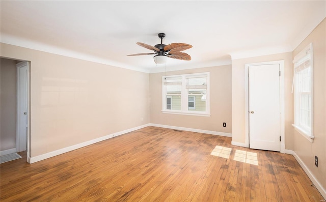 spare room with visible vents, a ceiling fan, baseboards, and light wood finished floors