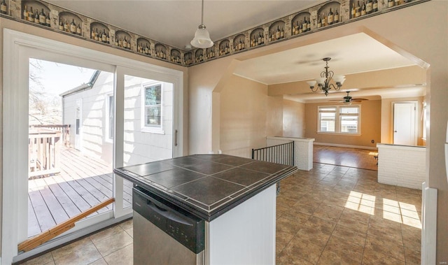 kitchen with baseboards, arched walkways, tile counters, dishwasher, and open floor plan