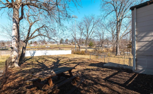 view of yard with a water view and fence