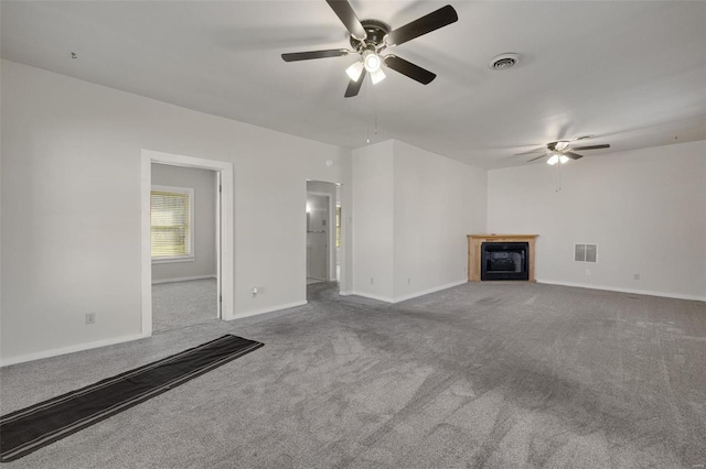 unfurnished living room featuring visible vents, a fireplace, baseboards, and carpet floors