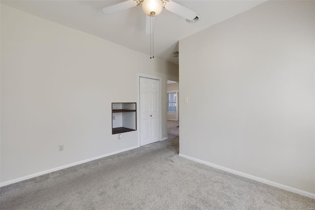 empty room with a ceiling fan, carpet, and baseboards