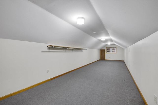 additional living space featuring vaulted ceiling, carpet flooring, and baseboards