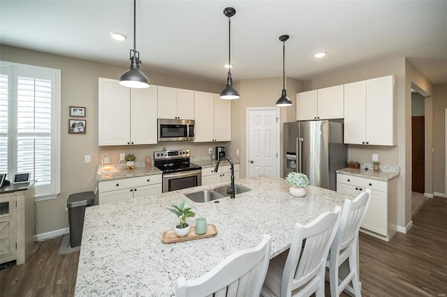 kitchen featuring a sink, stainless steel appliances, dark wood-style flooring, and white cabinetry