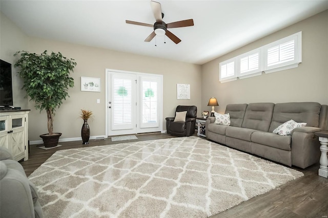 living area featuring a ceiling fan, wood finished floors, and baseboards