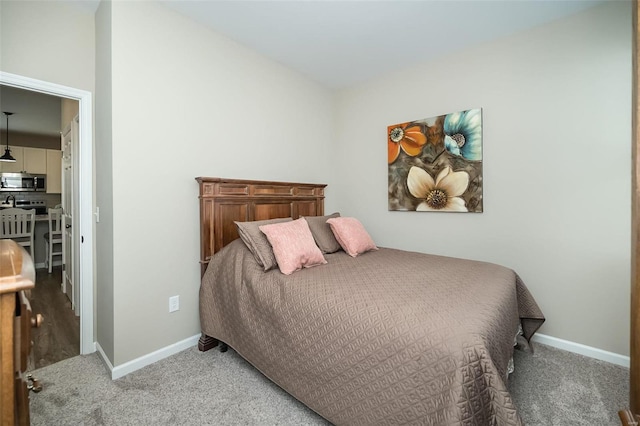 carpeted bedroom featuring baseboards