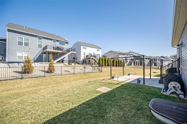 view of yard featuring a patio area, a residential view, and fence