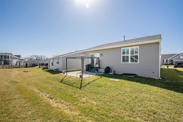 back of house with a gazebo, a lawn, a residential view, and a patio