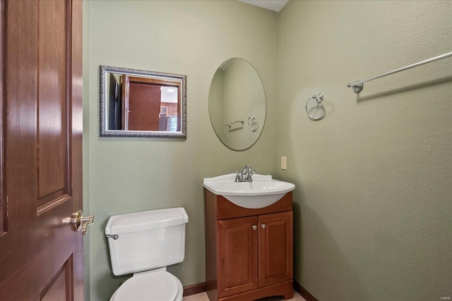 bathroom with toilet and vanity