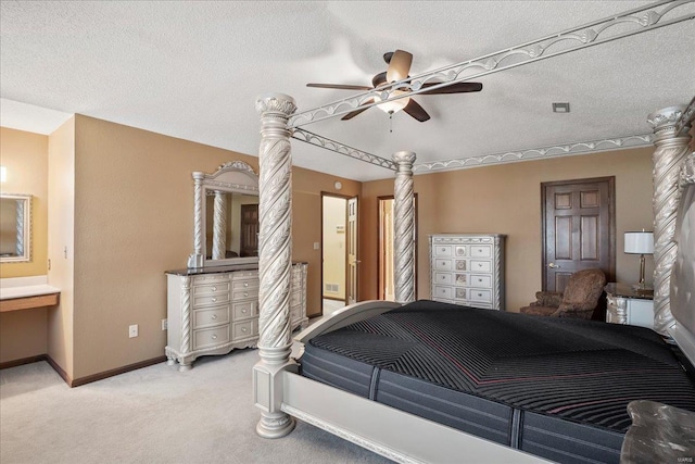 bedroom featuring baseboards, light carpet, a textured ceiling, and ensuite bath