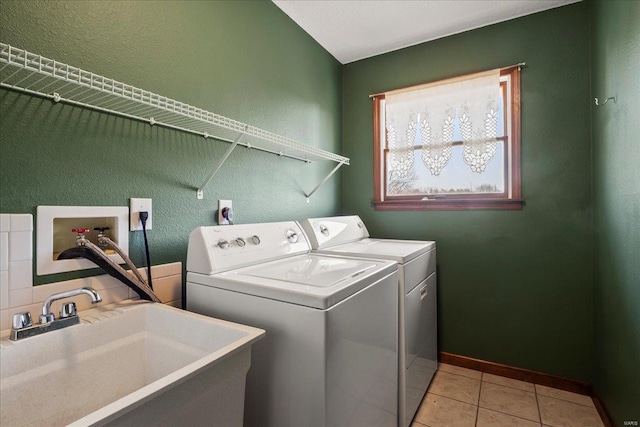 laundry room featuring washer and clothes dryer, a sink, light tile patterned floors, baseboards, and laundry area