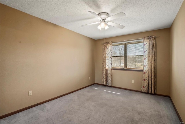 unfurnished room featuring a textured ceiling, baseboards, and carpet