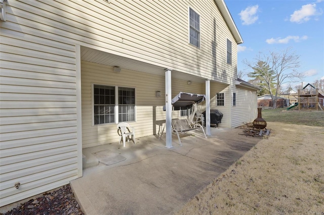 view of patio featuring area for grilling and a playground