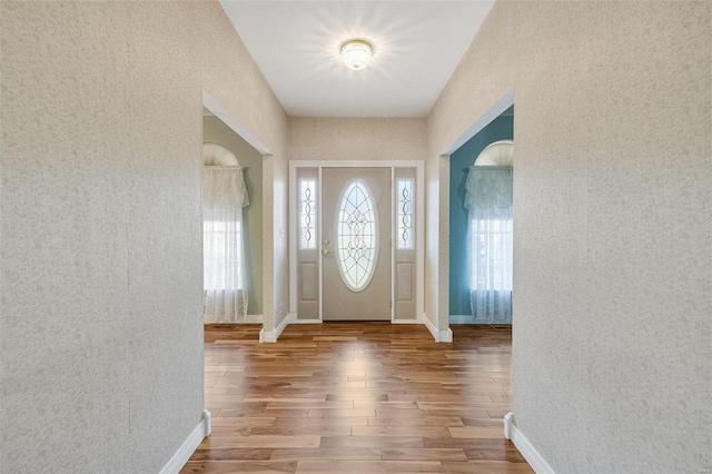 entrance foyer with wood finished floors and baseboards