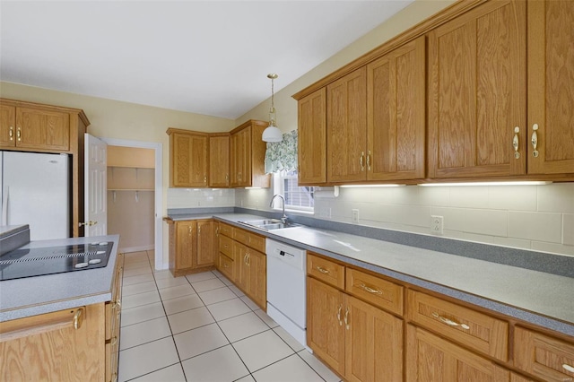 kitchen with pendant lighting, a sink, backsplash, white appliances, and light tile patterned floors