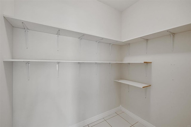 spacious closet with light tile patterned floors