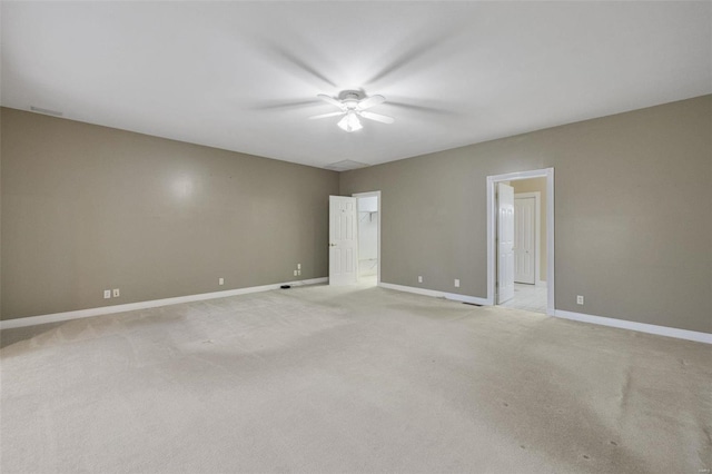 empty room featuring light colored carpet, baseboards, and ceiling fan