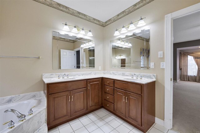 bathroom featuring tile patterned flooring, double vanity, a garden tub, and a sink