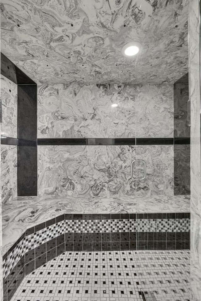 bathroom with tile patterned flooring and a stall shower