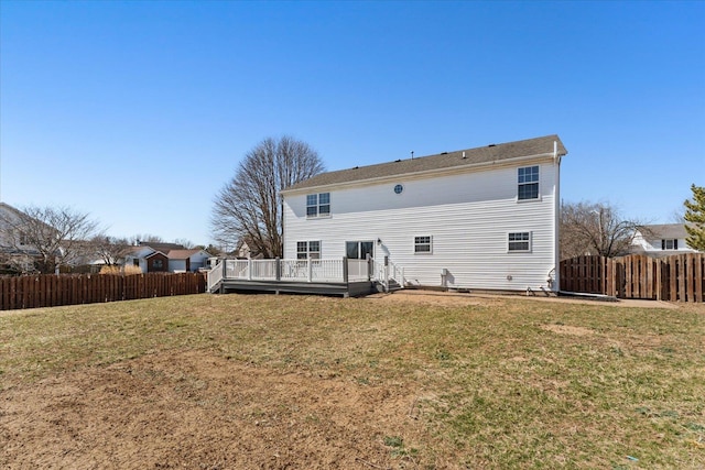 rear view of property with a yard, a fenced backyard, and a wooden deck