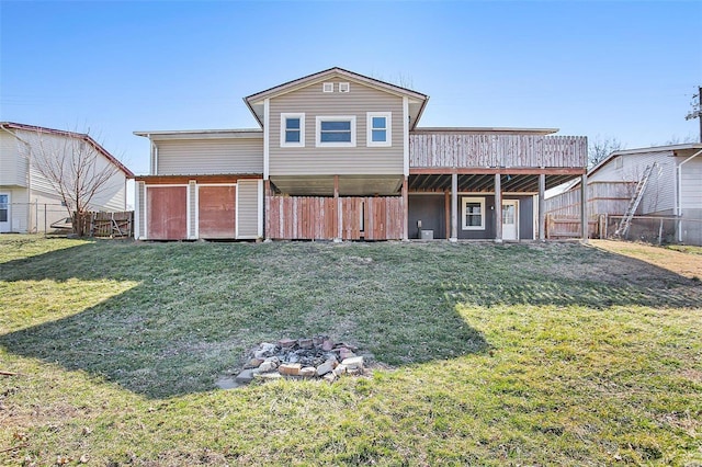 back of house with a lawn and fence