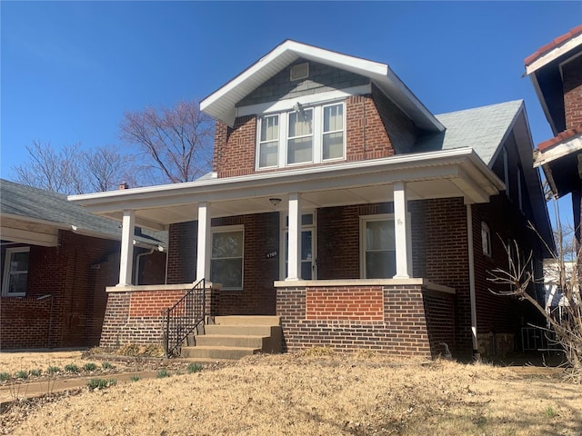 view of front of property with brick siding and a porch