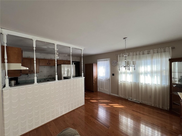 interior space featuring a chandelier and dark wood finished floors