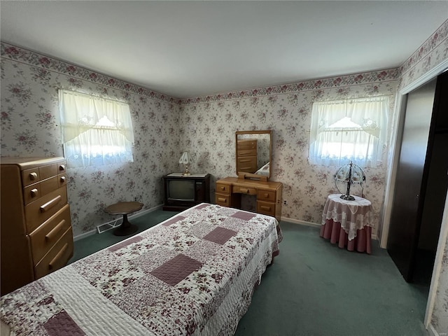 bedroom featuring baseboards, wallpapered walls, and carpet