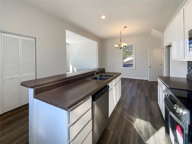 kitchen with a sink, electric range oven, white cabinets, stainless steel dishwasher, and dark countertops