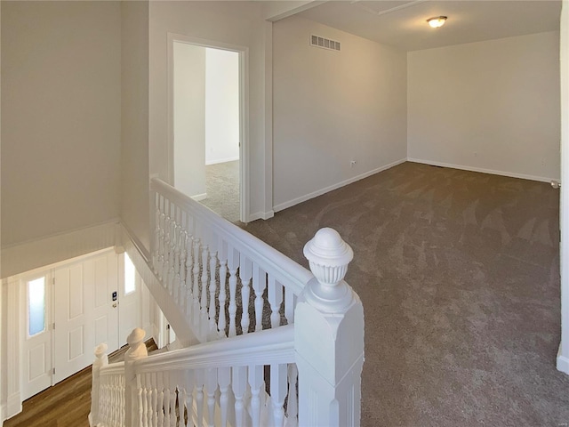 carpeted empty room featuring visible vents and baseboards