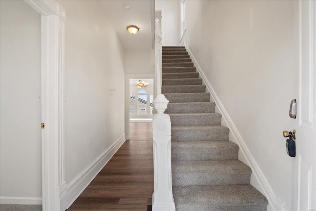 stairs with baseboards and wood finished floors