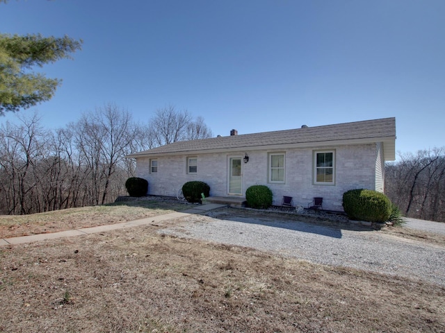 ranch-style house featuring brick siding