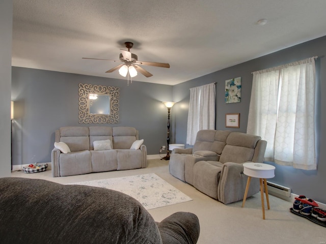 living room featuring baseboards, a ceiling fan, carpet, and a baseboard radiator